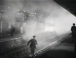 Albert Godby (Stanley Holloway) crosses the tracks to the refreshment room