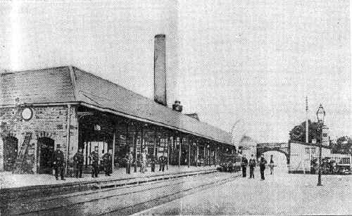 This picture of Carnforth Station, taken about 1870, is hardly recognisable by the present generation. Showing the top-hatted stationmaster and bearded railway servants and the old-fashioned locomotive drawn up against what is to-day the principal arrival platform for north-bound trains