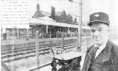 Railman Harold Lee, with 39 years' service with BR at Carnforth, seen against the station which has been changed by the erection of safety fences and the removal of the platform edge.