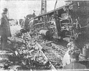 Watched by the divisional maintenance engineer, Mr. N.R.Peach, in charge of the operation, engineers toil to clear the track of wreckage.
