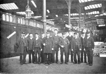 SOME OF THE STAFF AT CARNFORTH STATION, WITH MR. FARNWORTH (X), THE STATION SUPERINTENDANT IN CENTRE
