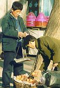 Street hawker sells apples.