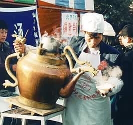 Cook uses extra large kettle.