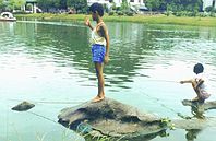 Young boys fishing in Guilin River.