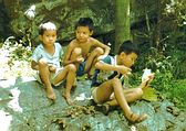 Chinese children sharing a small snack.