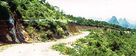 Guilin mountains scarred by track.