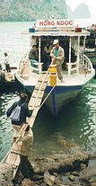 Tourists walk gang plank.