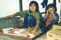 Children sell from boat.