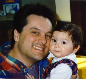 Father cuddles his infant daughter. Image copyright (C) 1998, administered by Russell Brown and may not be copied without permission.