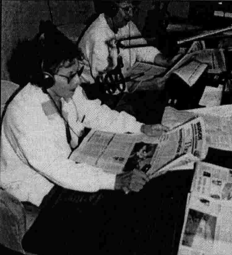 A volunteer reading the newspaper
