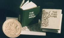 Photo of book compared with 1 coin.