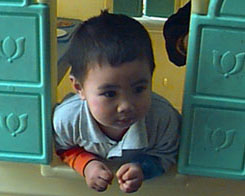 phillip playing in the Mc D's toy house
