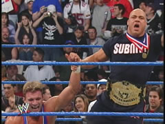 Haas celebrates a victory with Kurt Angle