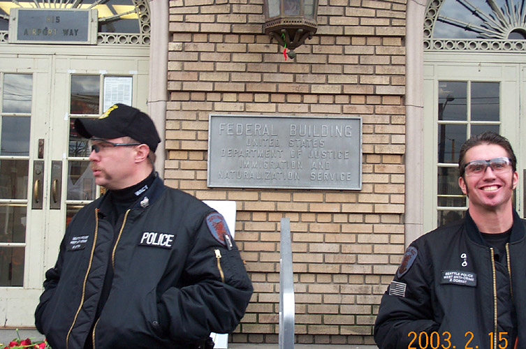 Cop Grinning in Front of Immigration and Naturalization Building