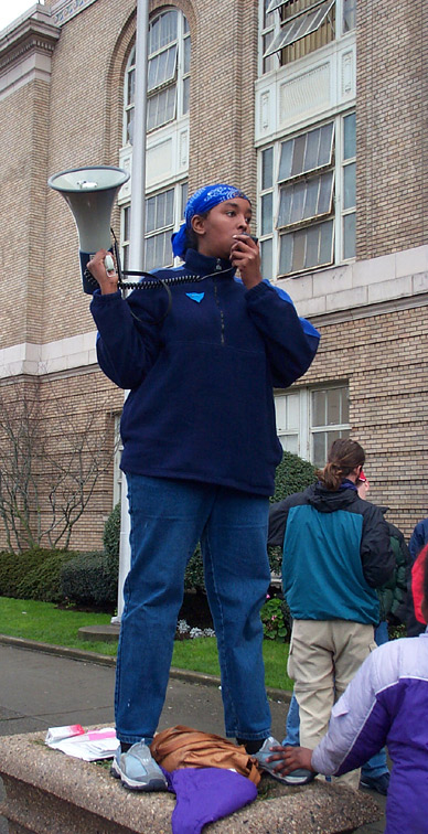 Bullhorn Lady Steadied by Friend
