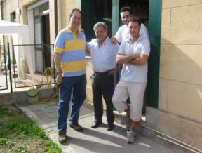 Alex and the Ottavianellis (father and sons) outside the factory entrance. 