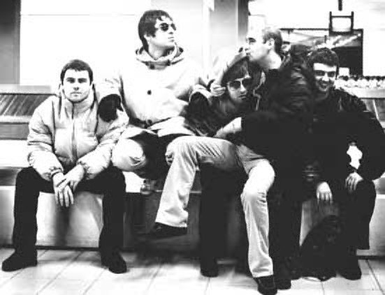 The band. Bonehead kissing Noel.