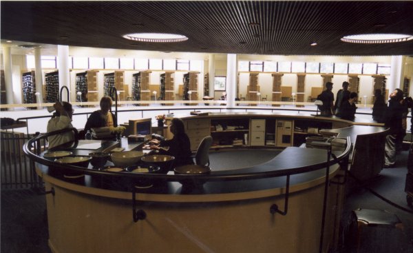 Photo from the entry looking toward the rear of the library, with the circulation desk and the middle skylights in view. 