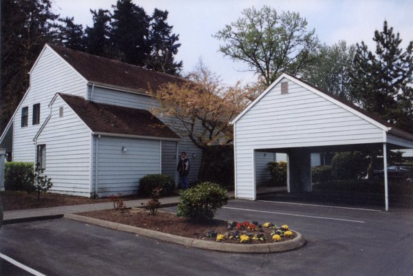 Photo of the entry of the condo as the focus. The park is in the background and the picture is facind south-west.