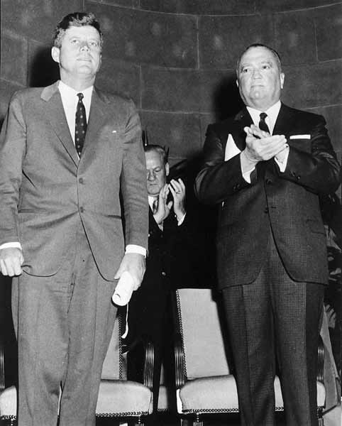 President John F. Kennedy and FBI Director J. Edgar Hoover stand together at an appearance in this undated photo.